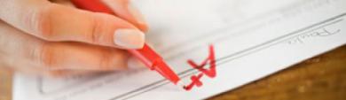 image of a hand writing A+ on a paper